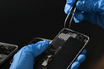 Technician repairing the Cell phone parts and tools for recovery repair phone smartphone and...