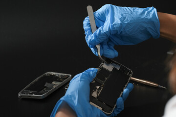 Technician repairing the Cell phone parts and tools for recovery repair phone smartphone and...