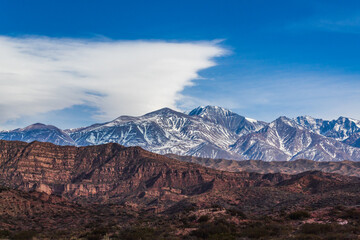 Mountains of the Potrerillos covered by snow in the field.