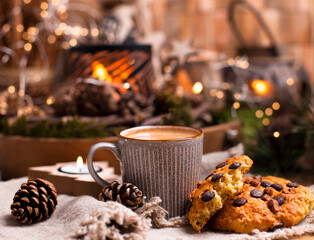 Mug of cocoa with chocolate chip cookies on a wooden table. Christmas drink and biscuit, festive decoration with garlands. Retro photo Happy New Year. High quality photo