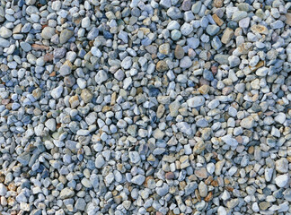 Texture of coloured high-contrast roll gravel, background wallpaper