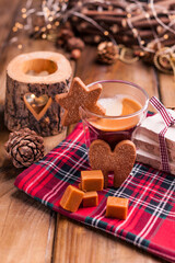 Espresso coffee, torrone, cookies and caramel on a wooden table. Christmas drink and festive decorations with garlands. Retro photo Happy New Year. High quality photo