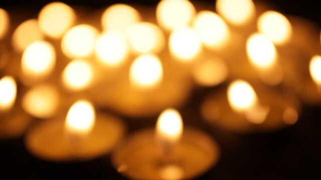 Burning candles out of focus, background, lots of Christmas candles, bokeh.