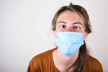 Woman wearing medical mask on a white background. Isolated. Woman with medical and face mask. Global call to stay home