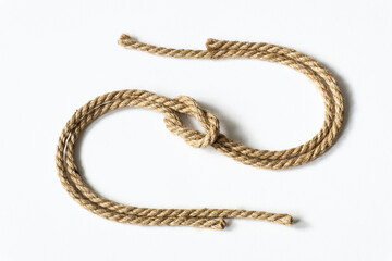 S-shaped jute rope with nautical knot on white background.