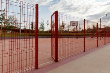 Entrance to the basketball court, outdoor sports ground, park, trees, sky.