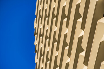 Abstract line pattern of architecture geometric background. Details of balcony building against blue sky