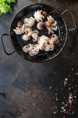 octopus raw seafood fresh baby size on the table serving size top view copy space for text diet pescetarian food background rustic