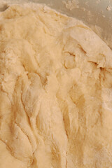 Raw dough mixed in a bowl for making homemade dumplings