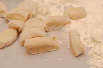 Sliced raw dough into pieces prepared for cooking homemade dumplings