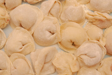 Homemade dumplings are put together on a Board in the kitchen