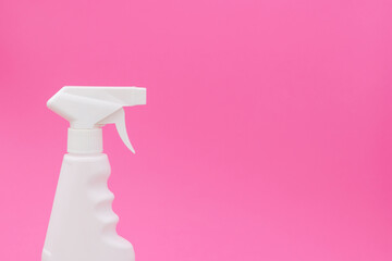 Cleaning spray on a pink background.