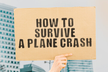 The phrase " How to survive a plane crash " on a banner in men's hand with blurred background. Recommendation. Information. Tragedy. Airplane accident