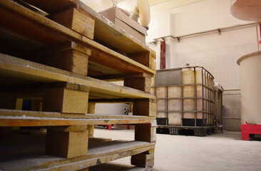 Wooden pallets stacked in a production area. Workshop for the production of paint.