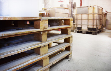 Wooden pallets stacked in a production area. Workshop for the production of paint.