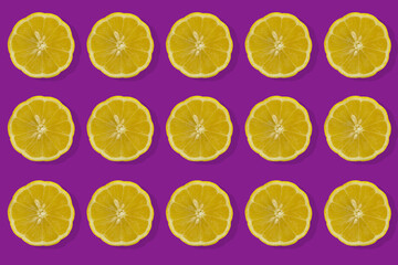 slices of ripe lemon on a purple background