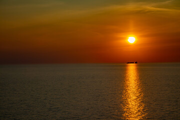 Sailing boat under the sun goes down