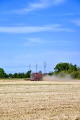 Fototapeta premium A combine is seen harvesting wheat