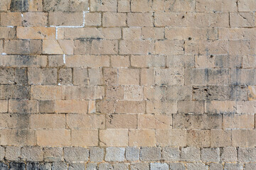 Old stone facade of a historic Mediterranean coastal building.