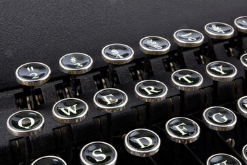 closeup of the QWERTY keys of a grungy old 1940's portable reporter's manual typewriter