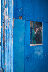 Blue haired girl photographer shoots in mirror 