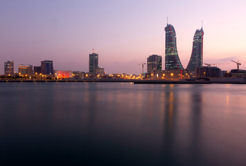 MANAMA , BAHRAIN - DECEMBER 19: Bahrain Financial Harbour with dramatic hue in the sky at dusk, December 19, 2019. It is one of tallest twin towers in Manama, Bahrain.