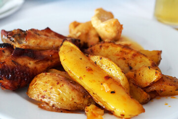 baked potatoes with meat on a white dish close-up