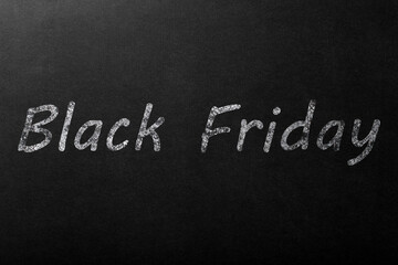 Obraz premium The inscription Black Friday in white chalk on a dark blackboard