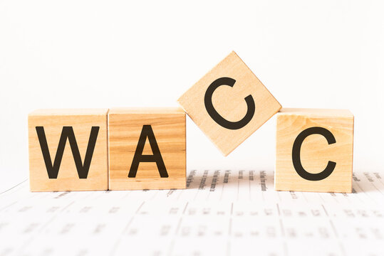 Word wacc. Wooden small cubes with letters isolated on white background with copy space available.Business Concept image.
