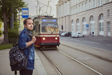 Fototapeta na wymiar Young man is waiting for tram.