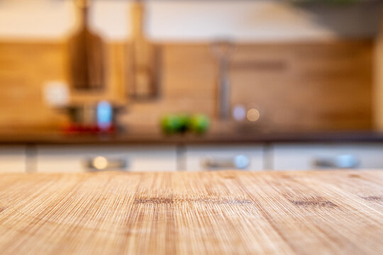 blurred kitchen and a wooden worktop