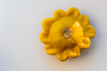 yellow ripe squash lie on a white background in light of sun