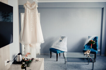 White wedding dress hanging in the bedroom. White bride dress