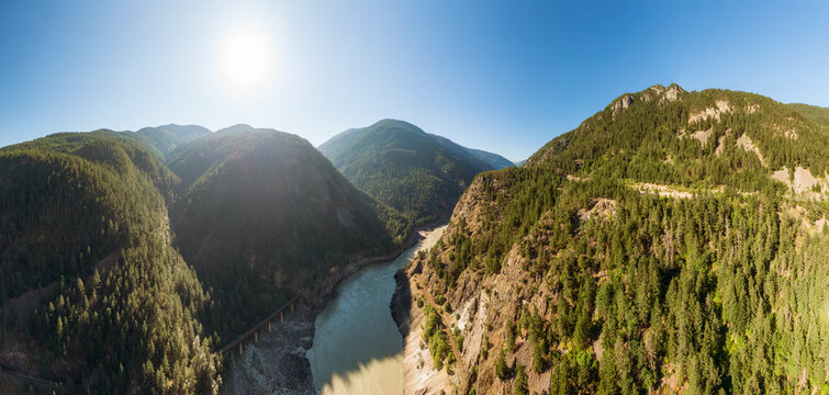 Beautiful Panoramic View of Canadian Nature and a Scenic Road, Trans-Canada Hwy, during sunny summer day. Aerial Drone Shot. Near Hells Gate, BC, Canada.