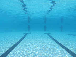 Underwater photo of deep turquoise empty swimming pool
