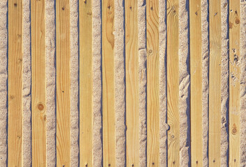 Beach sand between wooden planks as a travel background.