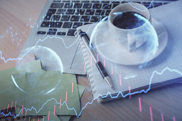 Double exposure of forex chart drawing and desktop with coffee and items on table background. Concept of financial market trading