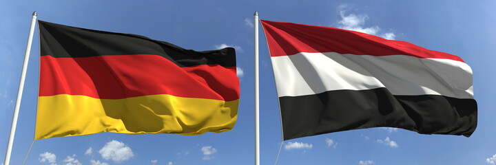 Waving flags of Germany and Yemen on flagpoles, 3d rendering