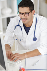 male doctor works with computer in the office