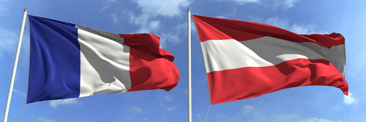 Flags of France and Austria on flagpoles. 3d rendering