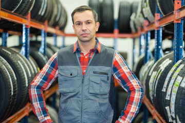 portrait of man stood between tyre rackings
