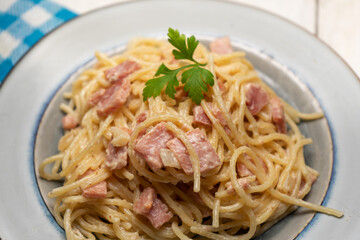 creamy spaghetti pasta with ham on white background