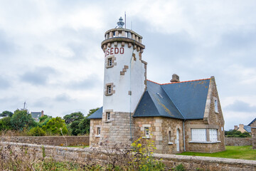 Fototapeta na wymiar Ile de Brehat, France - August 27, 2019: Lighthouse Phare de Rosedo on island Brehat at the Cotes d'Armor on English Channel in Brittany, France