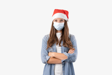 Young woman with medical mask and santa hat on white background. Christmas on quarantine.