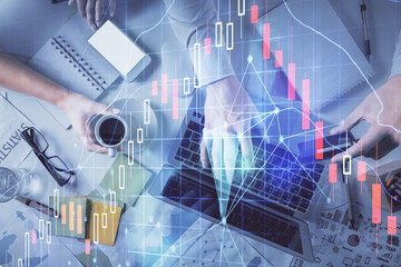 Double exposure of man and woman working together and forex graph hologram drawing. Financial analysis concept. Computer background. Top View.