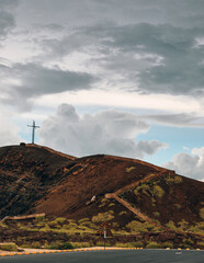 Stairs leading to the cruz de Boadilla on top of Masaya Volcano with nice clouds and green grass on the hill