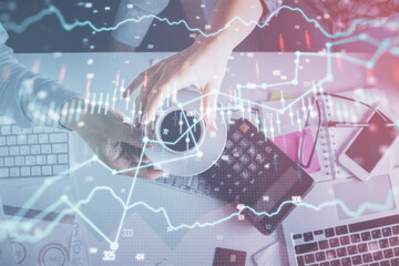 Double exposure of man and woman working together and financial chart hologram drawing. market analysis concept. Computer background. Top View.