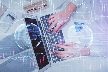 Double exposure of woman hands working on computer and forex graph hologram drawing. Top View. Financial analysis concept.