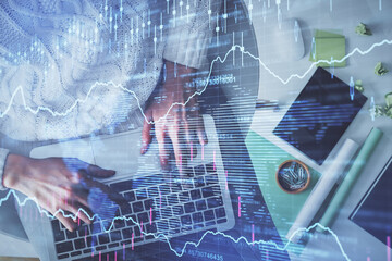 Multi exposure of woman hands working on computer and forex chart hologram drawing. Top View. Financial analysis concept.