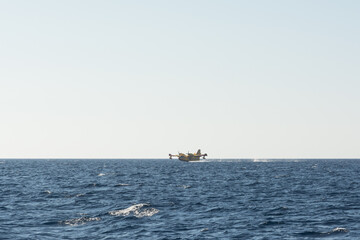 propeller firefighters plane taking water from the sea